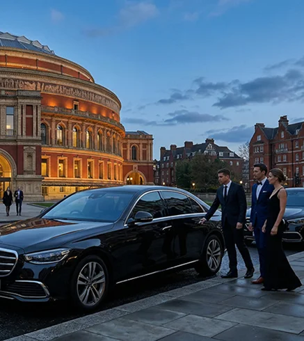 Professional chauffeur beside an executive vehicle